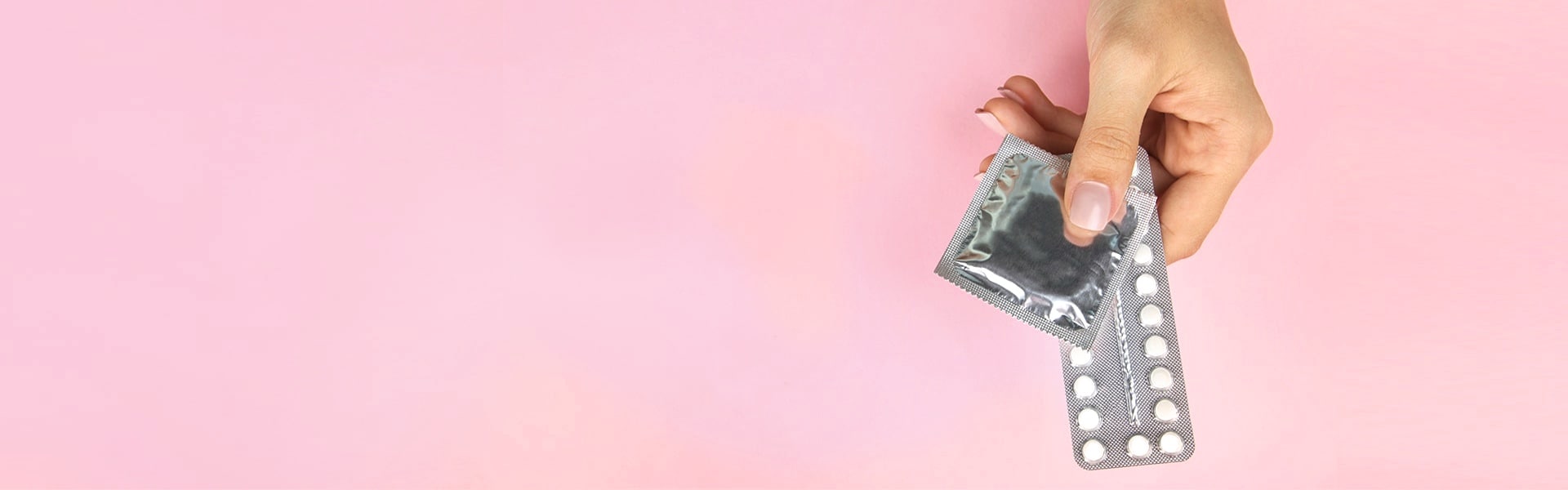 Hand holding contraceptives